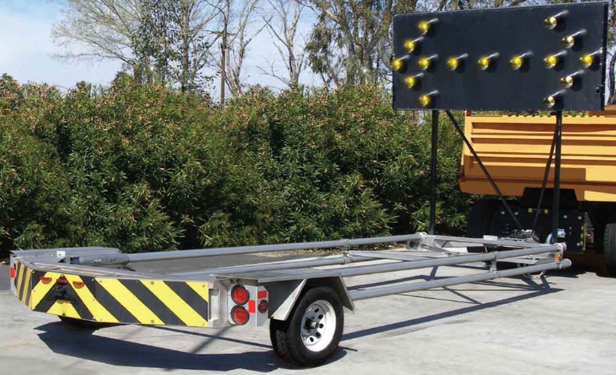A trailer with a yellow and black stripe on it