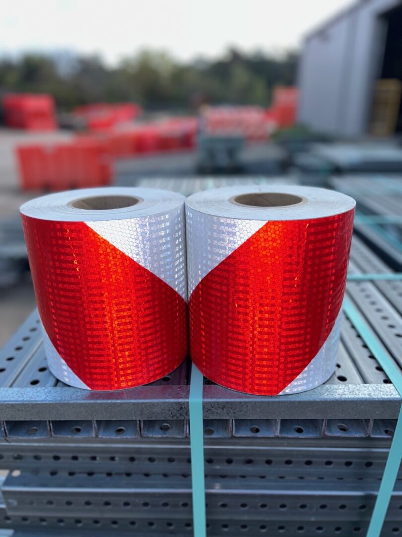 dead end tape Two rolls of red and white tape on a rack.